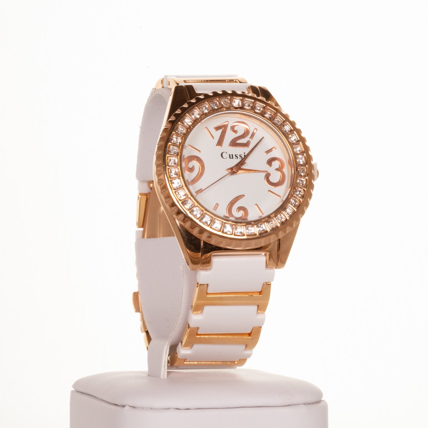 CUSSI dámské hodinky v barvě růžového zlata  s bílým řemínkem a krystaly křemene kolem ciferníku